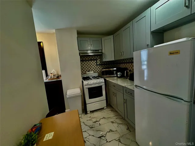 a kitchen with a refrigerator sink and stove