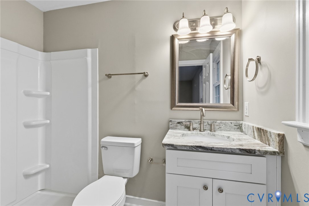 10731 Spring Run Road Chesterfield, VA 23832 - Photo 22 of 33 a bathroom with a sink vanity mirror and toilet