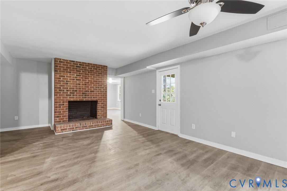 10731 Spring Run Road Chesterfield, VA 23832 - Photo 24 of 33 an empty room with a fireplace and wooden floor