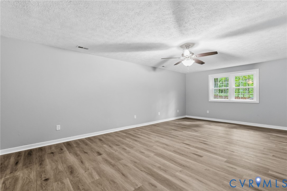 10731 Spring Run Road Chesterfield, VA 23832 - Photo 25 of 33 an empty room with wooden floor and windows