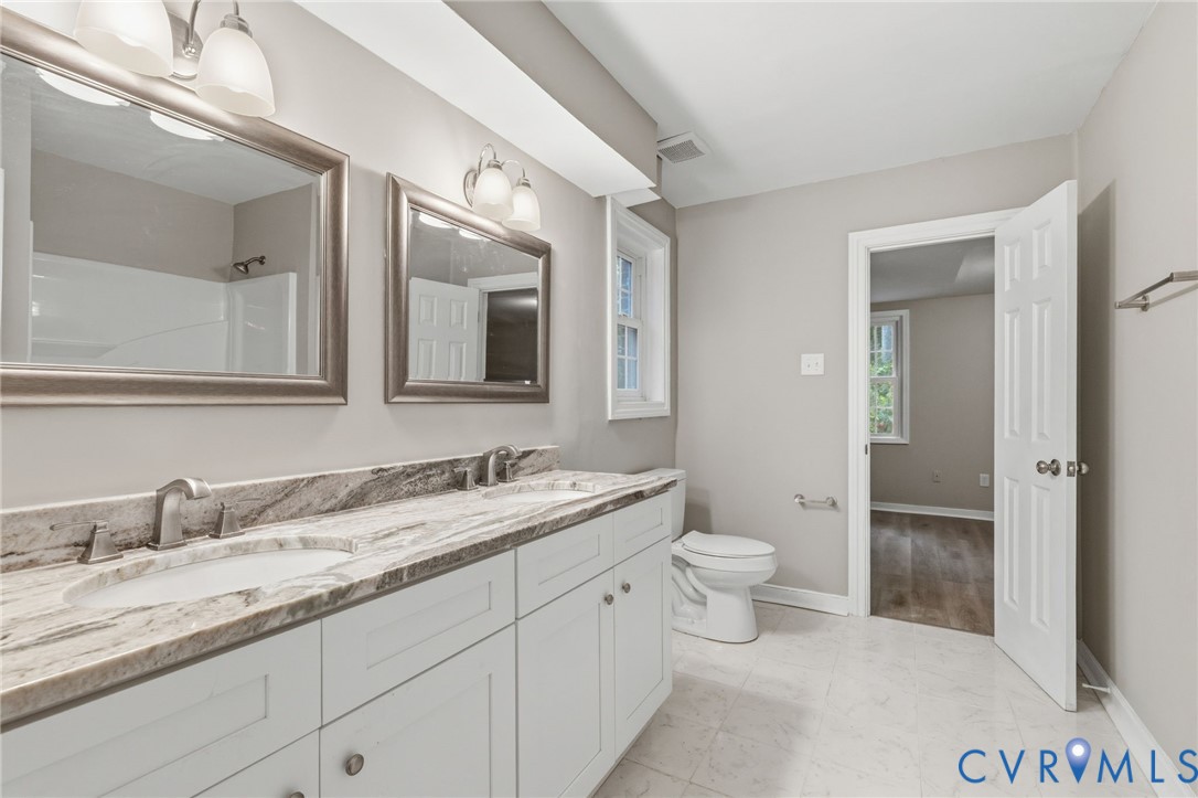 10731 Spring Run Road Chesterfield, VA 23832 - Photo 27 of 33 a bathroom with a toilet a double vanity sink and a mirror