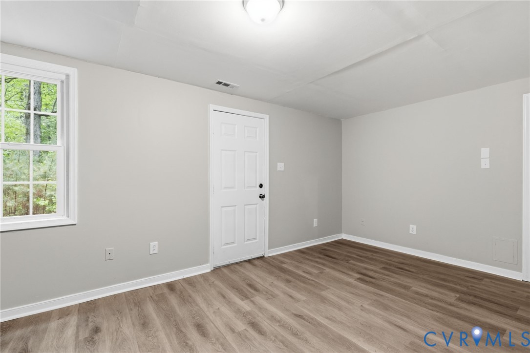 10731 Spring Run Road Chesterfield, VA 23832 - Photo 28 of 33 an empty room with wooden floor and windows