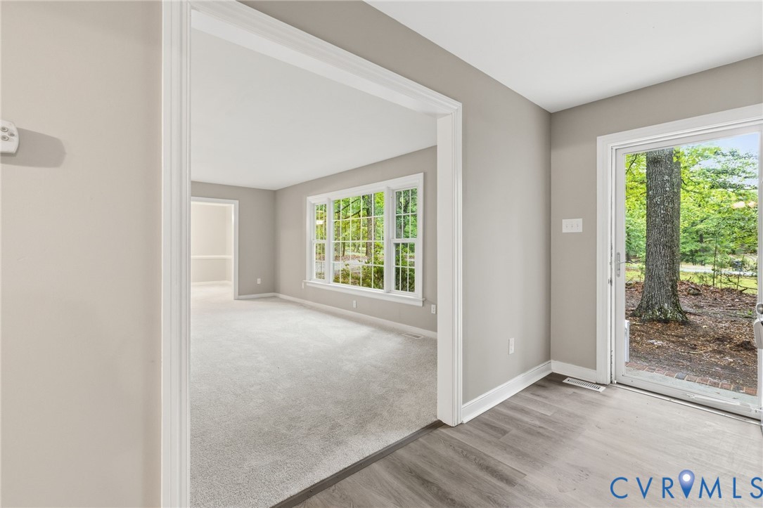 10731 Spring Run Road Chesterfield, VA 23832 - Photo 4 of 33 an empty room with wooden floor and windows
