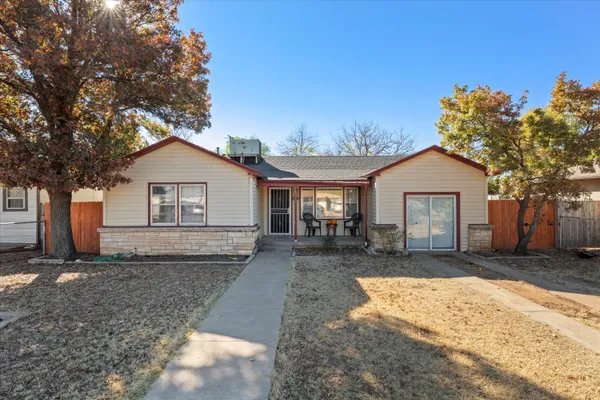 a front view of house with yard outdoor seating and barbeque oven