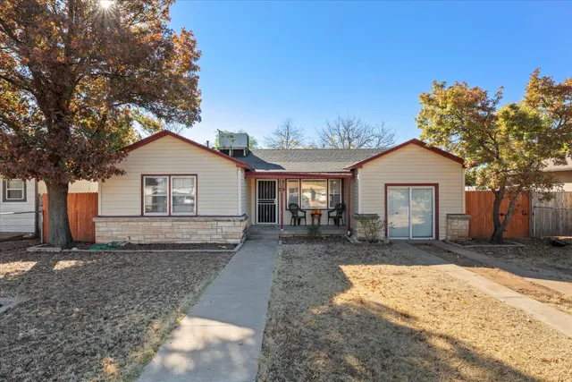 a front view of house with yard outdoor seating and barbeque oven