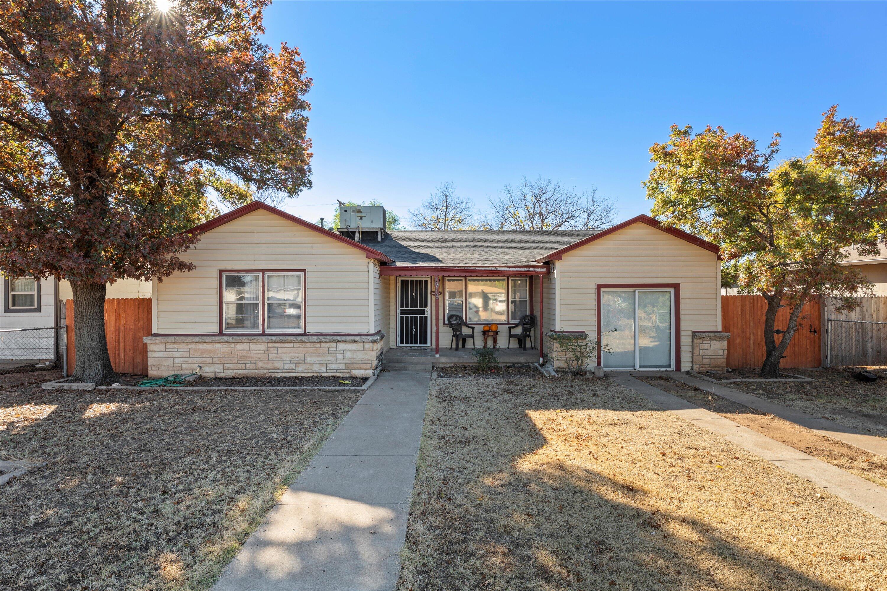 a front view of house with yard outdoor seating and barbeque oven