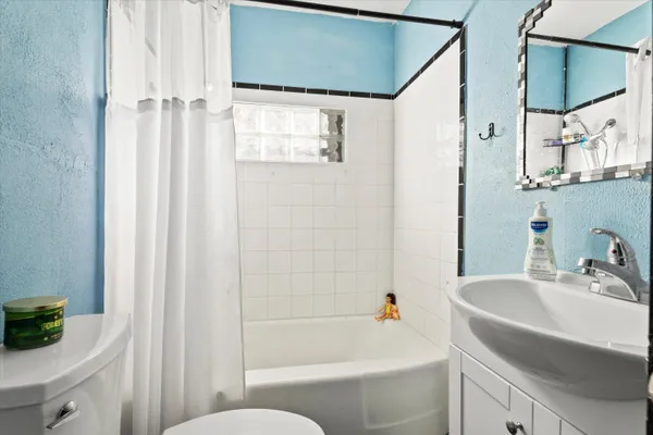 a bedroom with furniture and a window