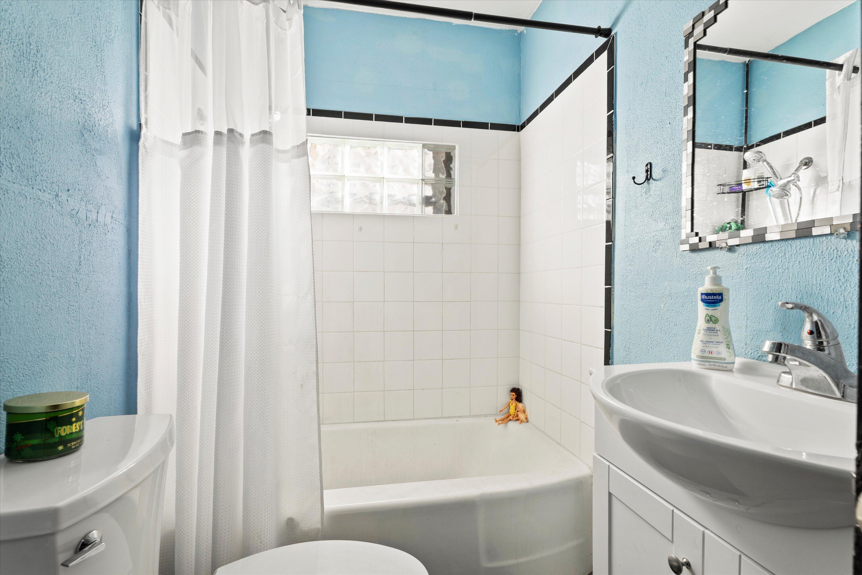 1915 37th Street Lubbock, TX 79412 - Photo 13 of 20 a bathroom with a sink a toilet and shower