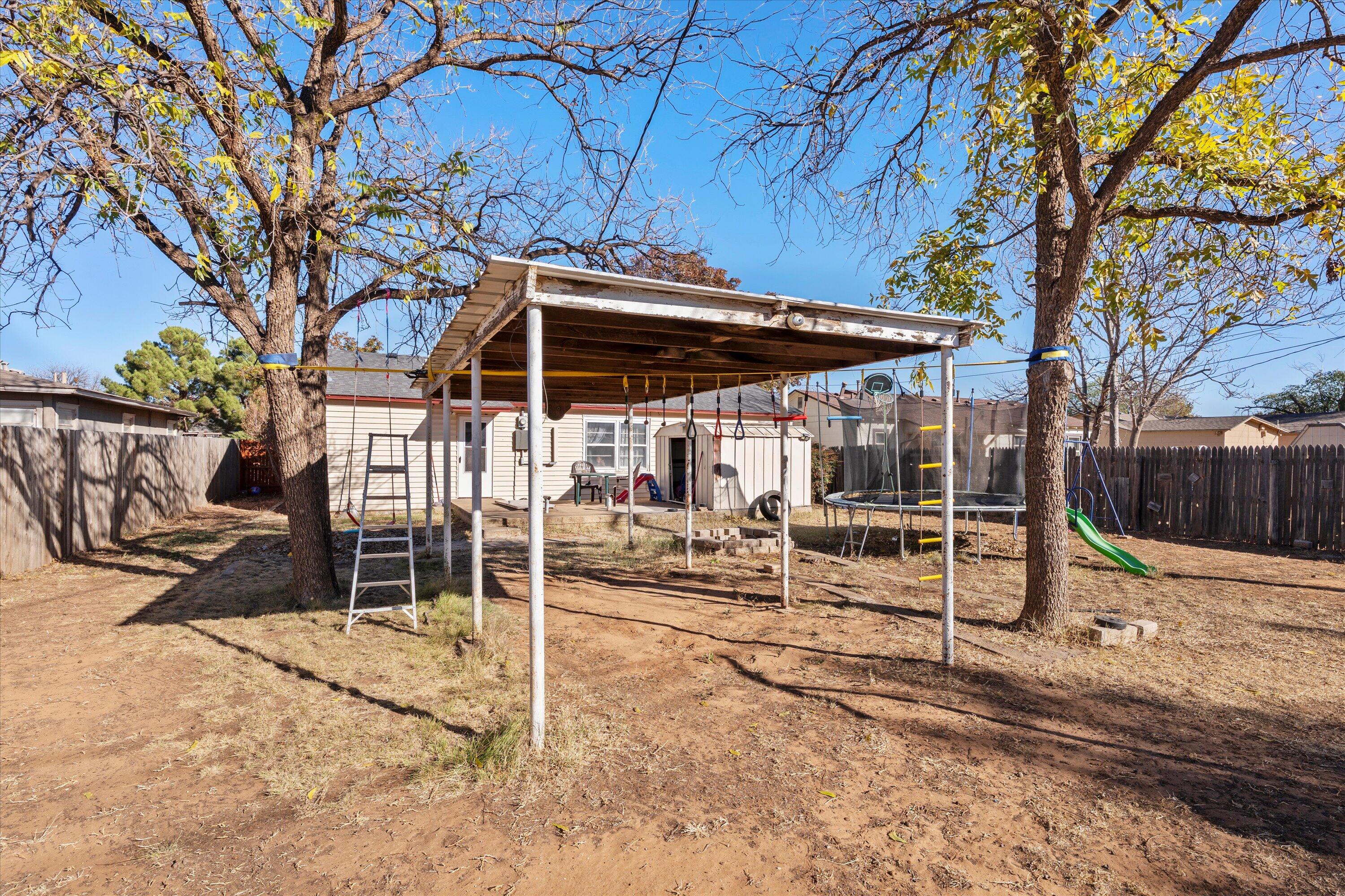 1915 37th Street Lubbock, TX 79412 - Photo 19 of 20 a patio with table and chairs and potted plants