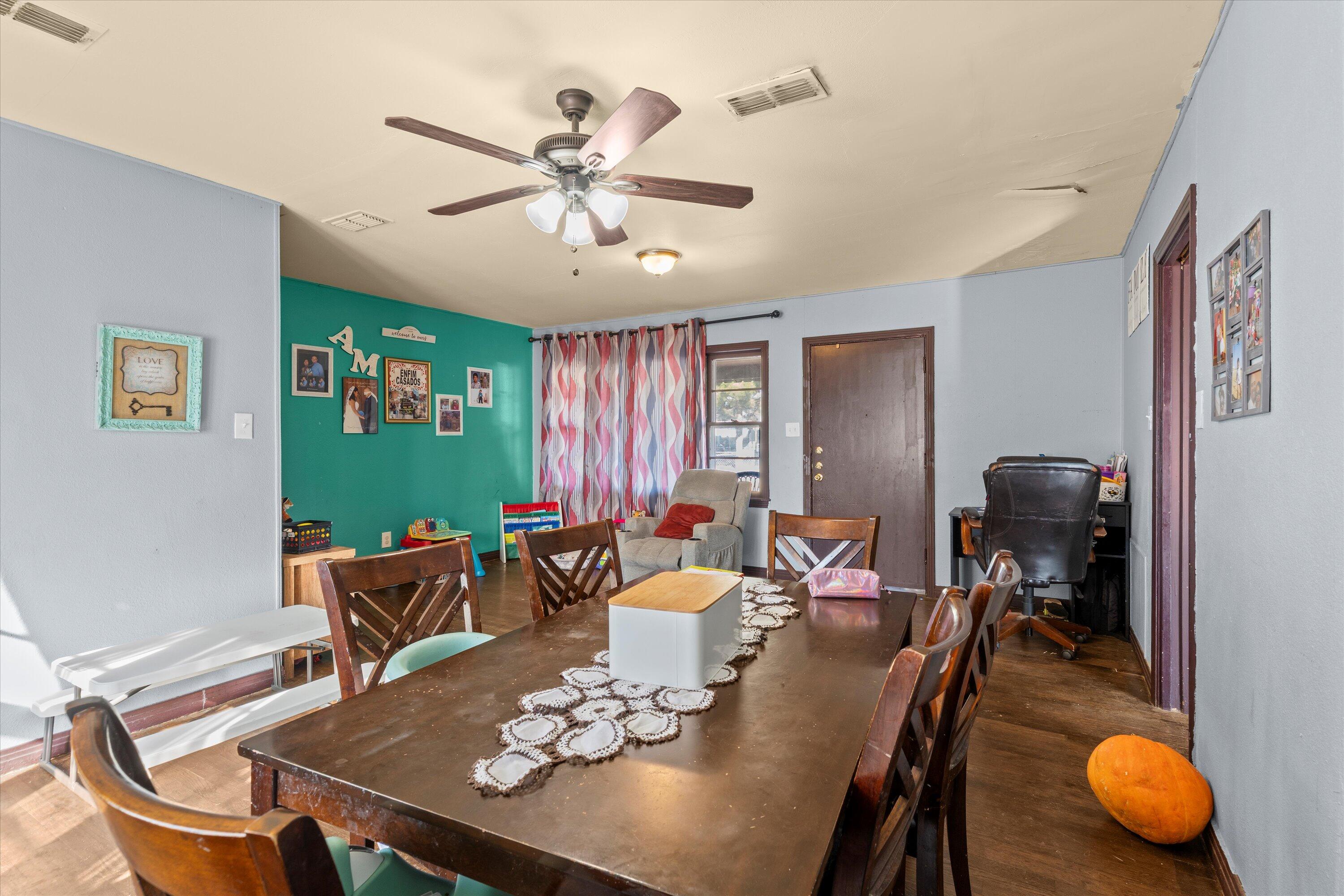 1915 37th Street Lubbock, TX 79412 - Photo 3 of 20 a view of a dining room with furniture and a chandelier