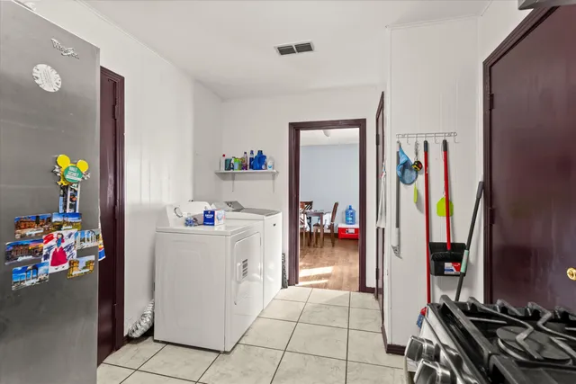 a kitchen with a refrigerator and cabinets