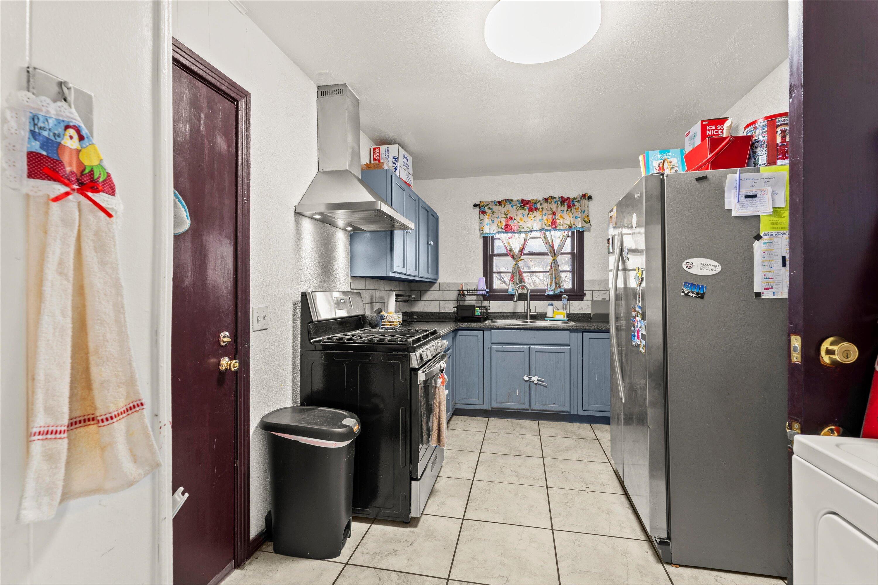 1915 37th Street Lubbock, TX 79412 - Photo 8 of 20 a kitchen with a refrigerator and cabinets