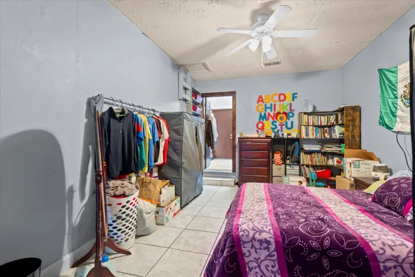 a bedroom with a bed and a desk