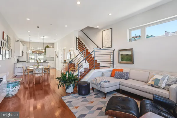 a living room with furniture and wooden floor