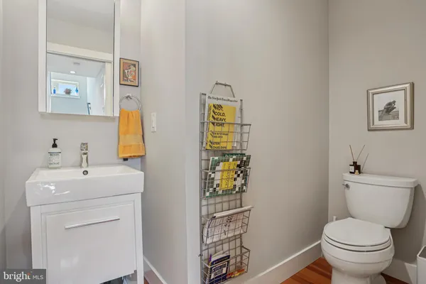 a bathroom with a toilet sink and mirror
