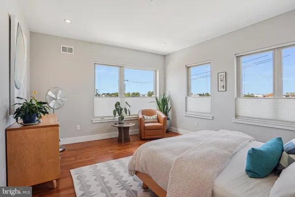 a bedroom with a bed and a potted plant