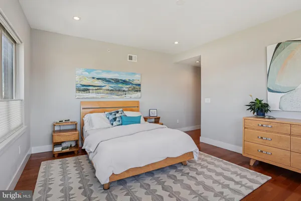 a bedroom with a bed and a dresser in it