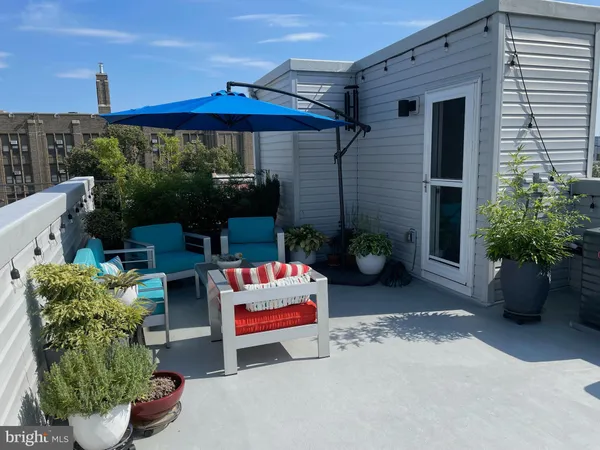 a view of a patio with couches and potted plants