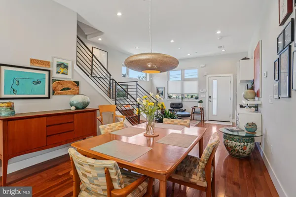 a dining room with furniture and wooden floor