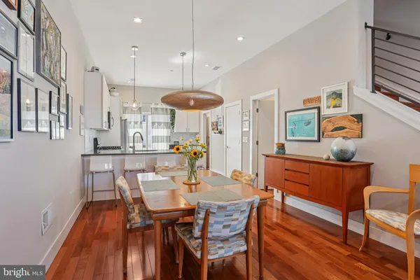 a view of a dining room with furniture and wooden floor