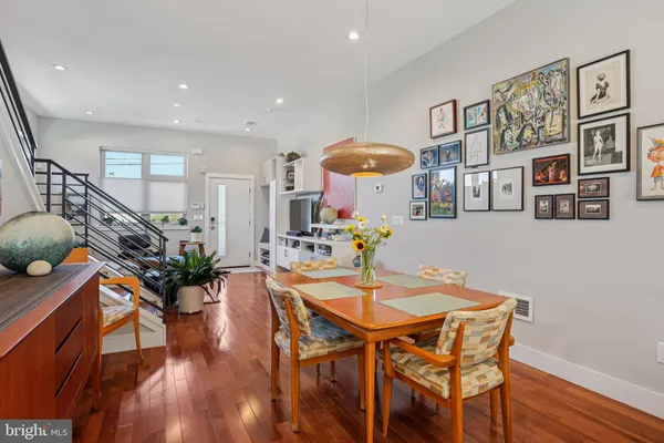 a dining room with furniture and wooden floor