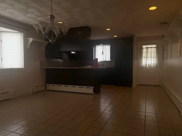 an empty room with windows and furniture