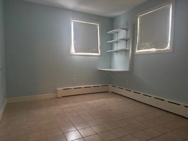 an empty room with a empty space and windows