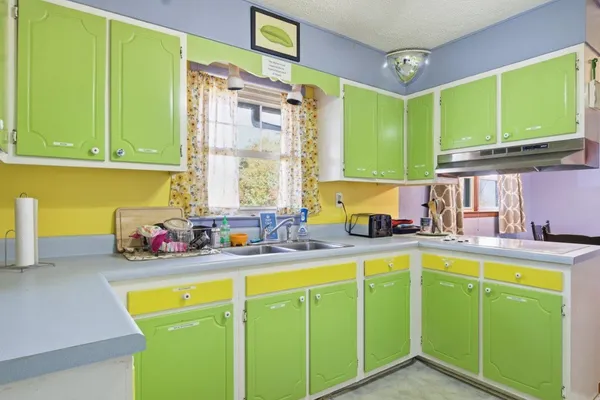 a kitchen with sink cabinets and a window