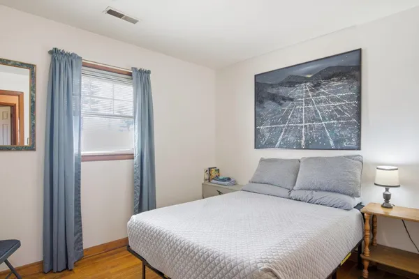 a bedroom with a bed and a window