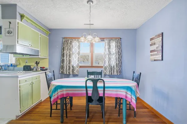 a view of a dining room with furniture and window