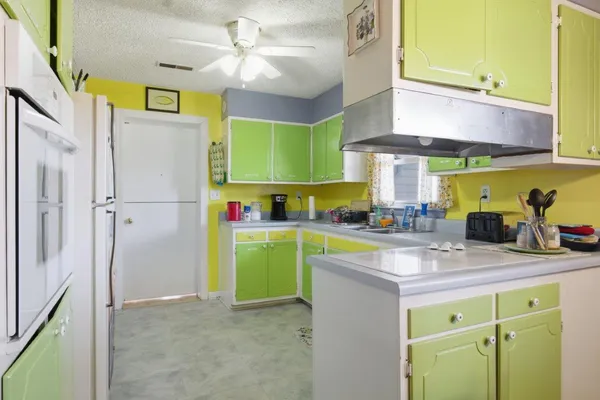 a kitchen with a refrigerator and a sink