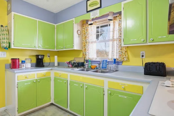 a kitchen with sink and cabinets