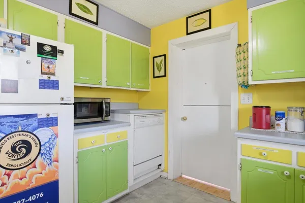 a kitchen with a refrigerator and a stove