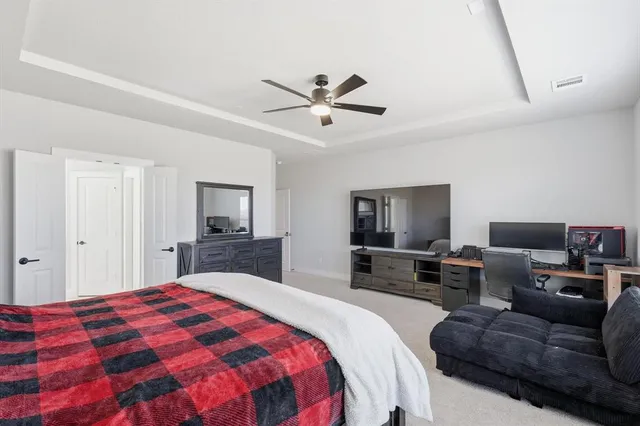 a spacious bedroom with a bed and a couch