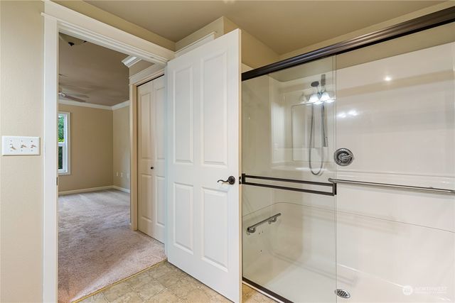 a bathroom with a glass shower door