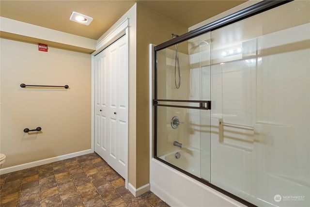 a bathroom with a shower and a glass door