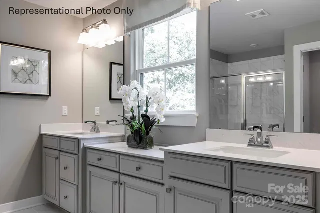 a bathroom with a sink double vanity and a mirror