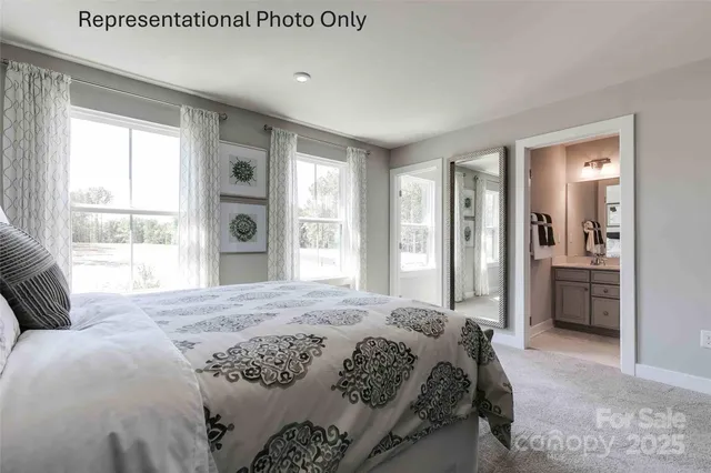 a bedroom with a balcony a bed and a large window