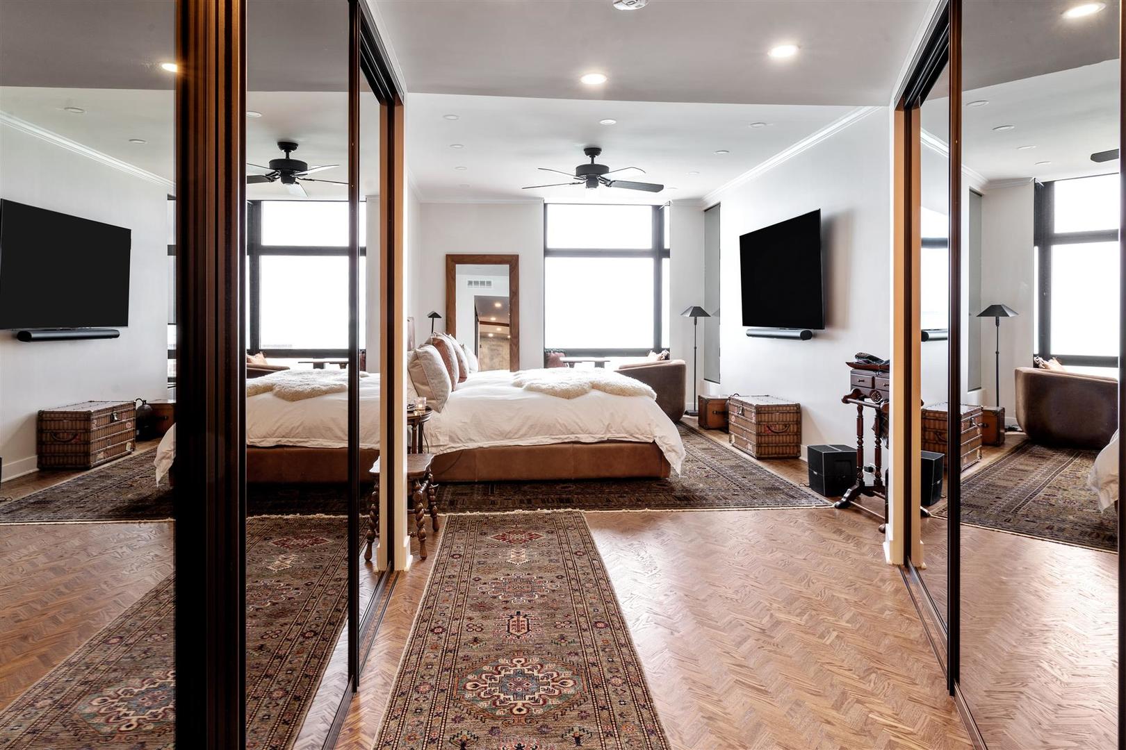 680 North Lake Shore Drive, Unit 1103 Chicago, IL 60611 - Photo 18 of 28 a bedroom with a bed and a flat screen tv