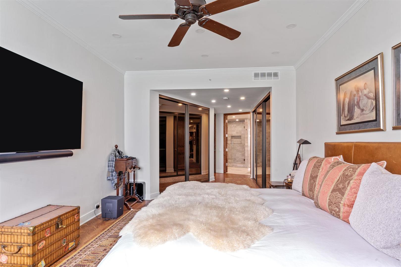 680 North Lake Shore Drive, Unit 1103 Chicago, IL 60611 - Photo 19 of 28 a bedroom with a bed and a flat screen tv