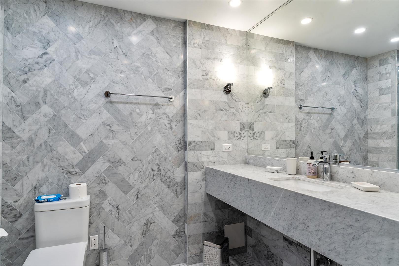 680 North Lake Shore Drive, Unit 1103 Chicago, IL 60611 - Photo 23 of 28 a bathroom with a sink a toilet a mirror and shower