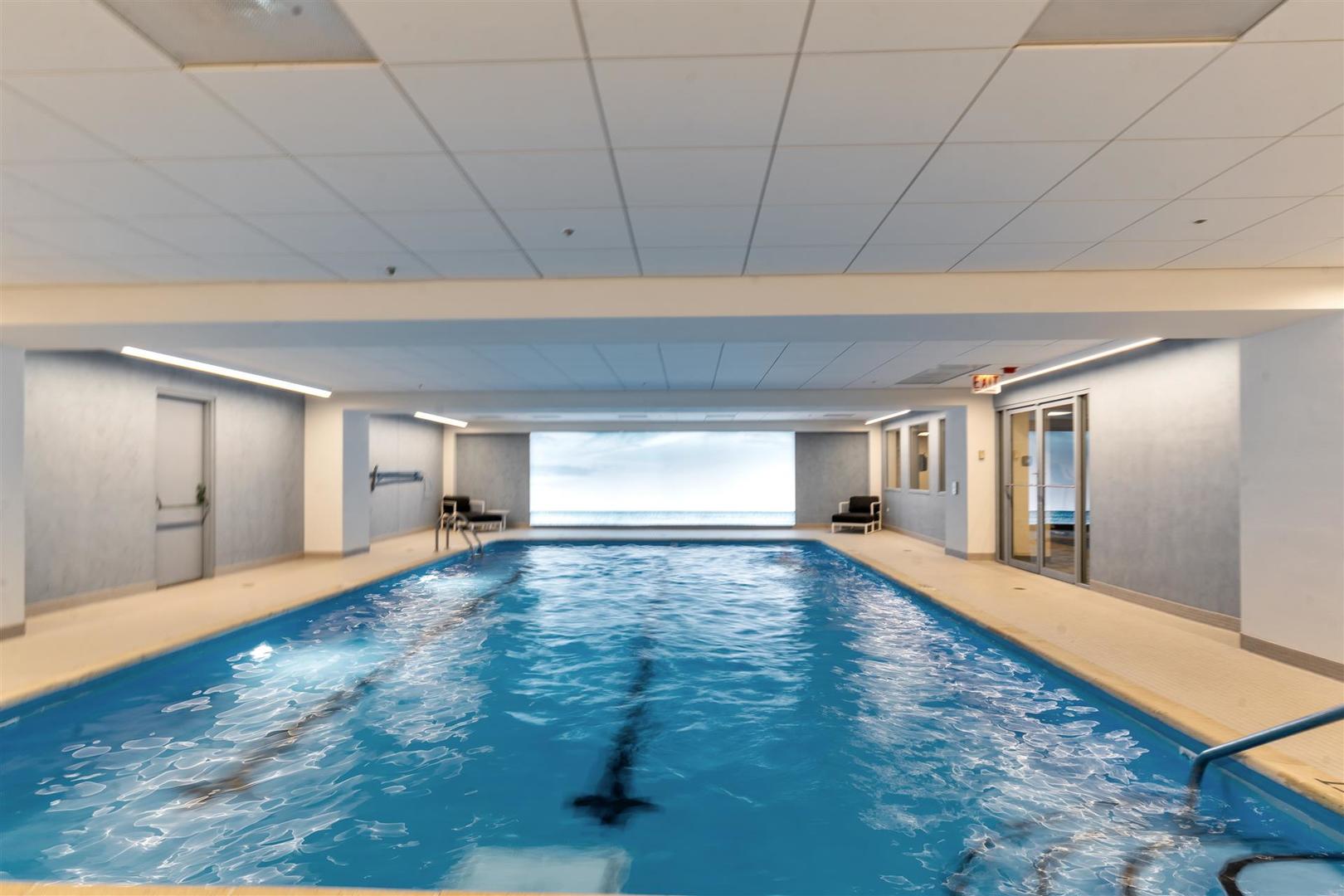 680 North Lake Shore Drive, Unit 1103 Chicago, IL 60611 - Photo 27 of 28 a big room with chandelier fan and windows