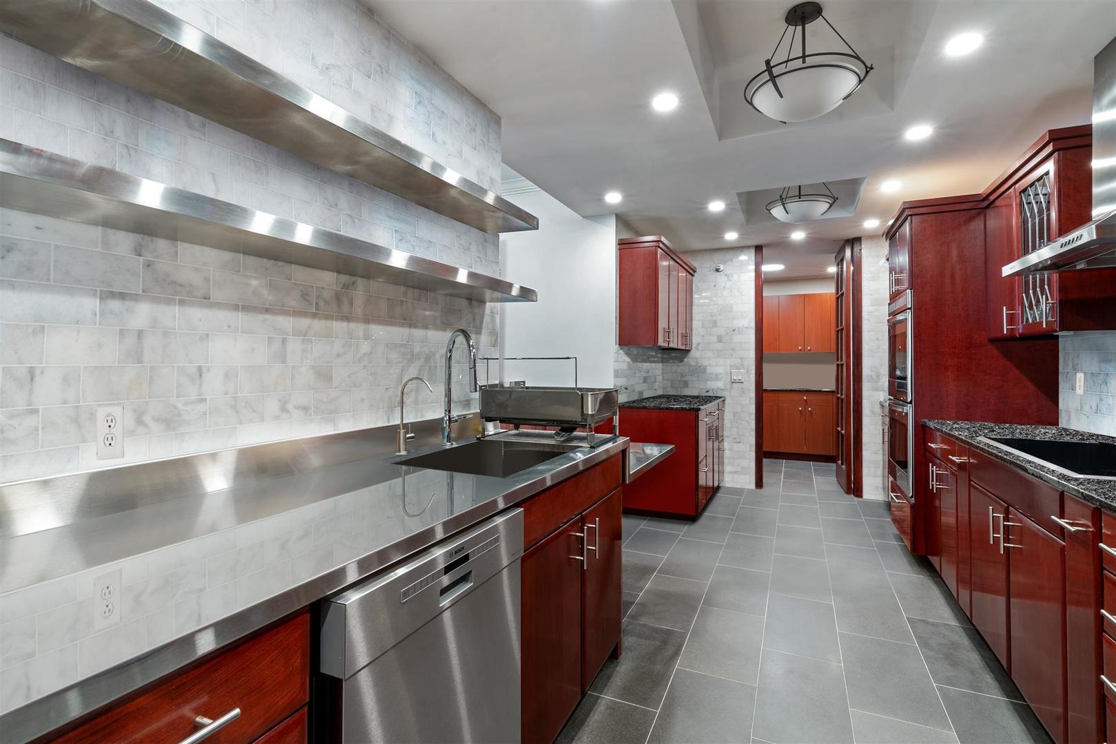 680 North Lake Shore Drive, Unit 1103 Chicago, IL 60611 - Photo 5 of 28 a kitchen with stainless steel appliances a sink a stove top oven a counter space and cabinets