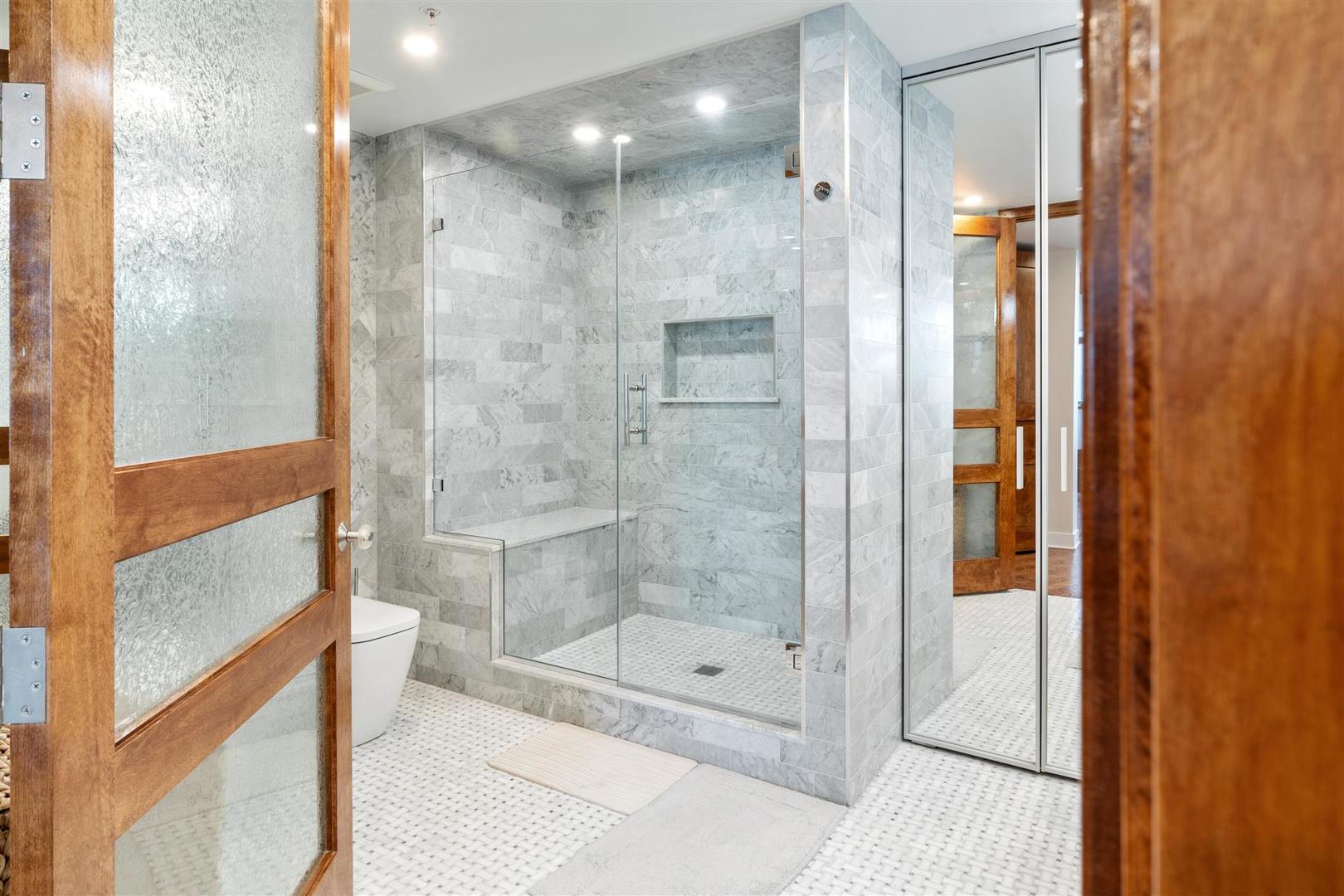 680 North Lake Shore Drive, Unit 1103 Chicago, IL 60611 - Photo 9 of 28 a bathroom with a shower and a glass door