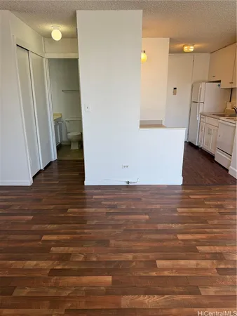 a bathroom with a granite countertop toilet sink and mirror