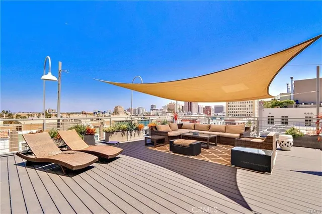 a view of a balcony with chairs and wooden floor
