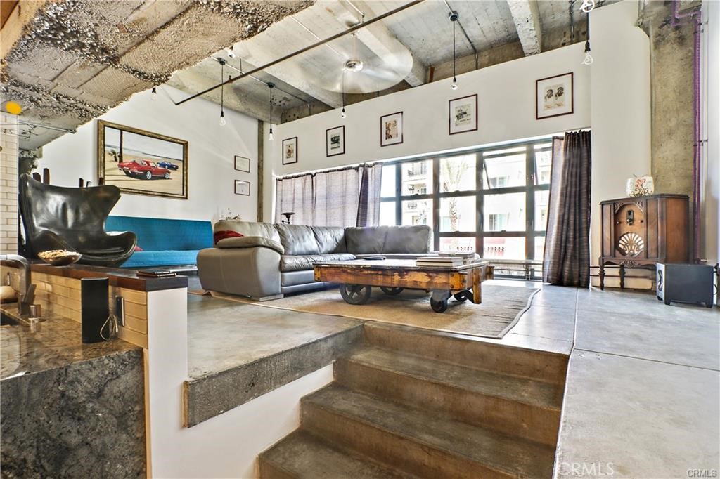 100 West 5th Street, Unit 2G Long Beach, CA 90802 - Photo 4 of 17 a living room with furniture and a flat screen tv