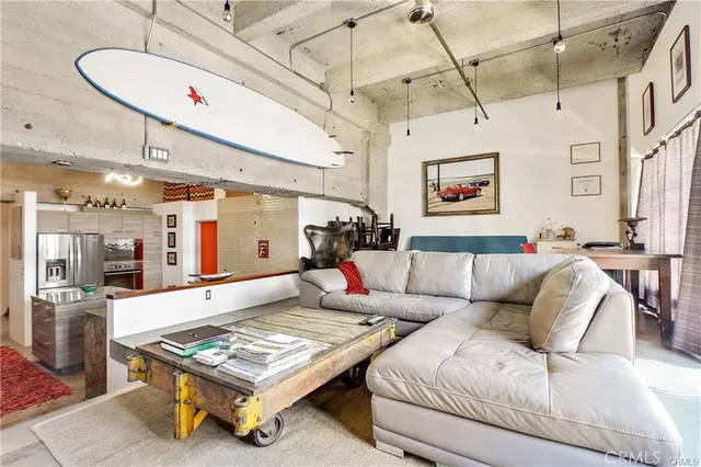 a living room with furniture a flat screen tv and a floor to ceiling window