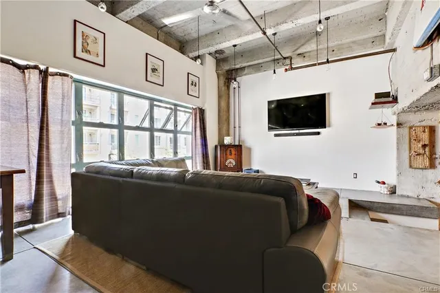 a living room with furniture rug and wall paintings