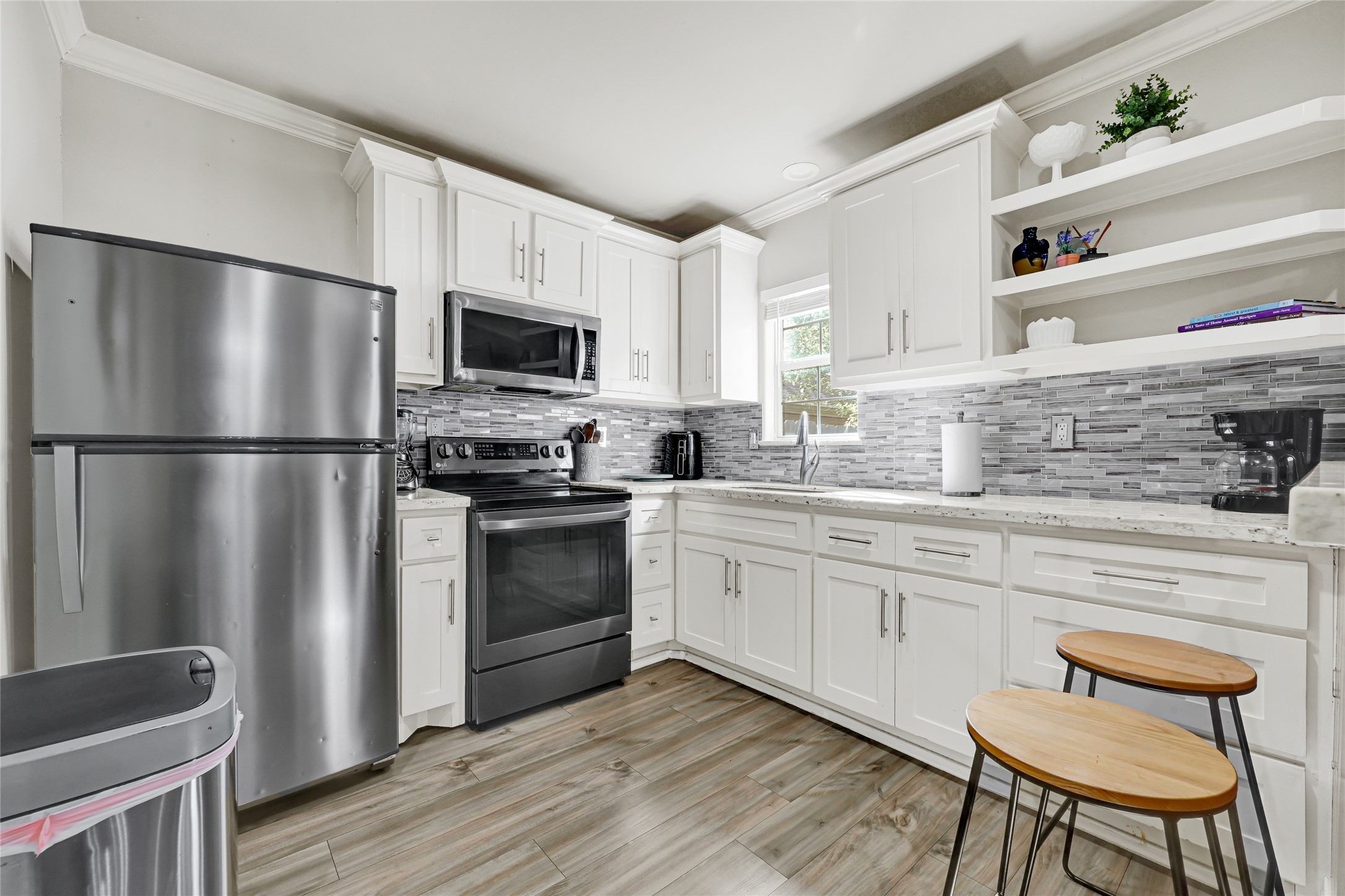 2809 Tooke Street Houston, TX 77023 - Photo 30 of 50 a kitchen with stainless steel appliances white cabinets and a refrigerator